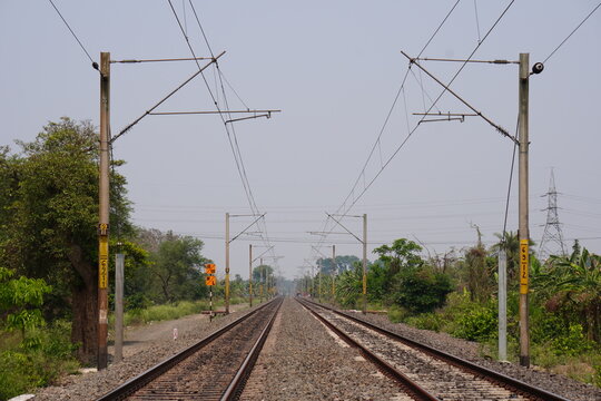The double-track railway line with overhead catenary infrastructure, which supplies electricity to trains along with the railway signal 