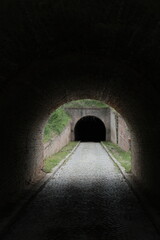 Dark tunnel inside Petrovaradin Fortress, Novi Sad, Serbia, leads into shadow and mystery. Captured in 2025, this historic passage evokes depth, silence, and forgotten history.