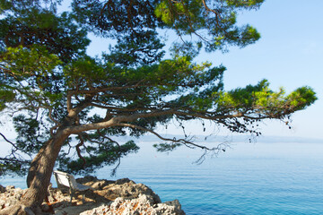 White bench on rocks near Adriati sea , Croatia	