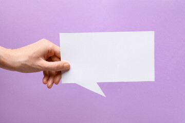 Woman holding blank speech bubble on lilac background, closeup. Space for text