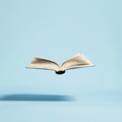   An open book floating in the air against a blue background with a book's shadow underneath it
