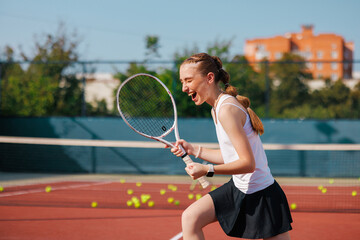 Ecstatic teenage tennis player celebrates win with passionate expression and clenched fists.
