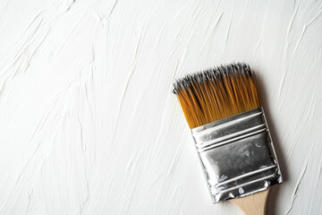 Brush on white textured wall, copy space.