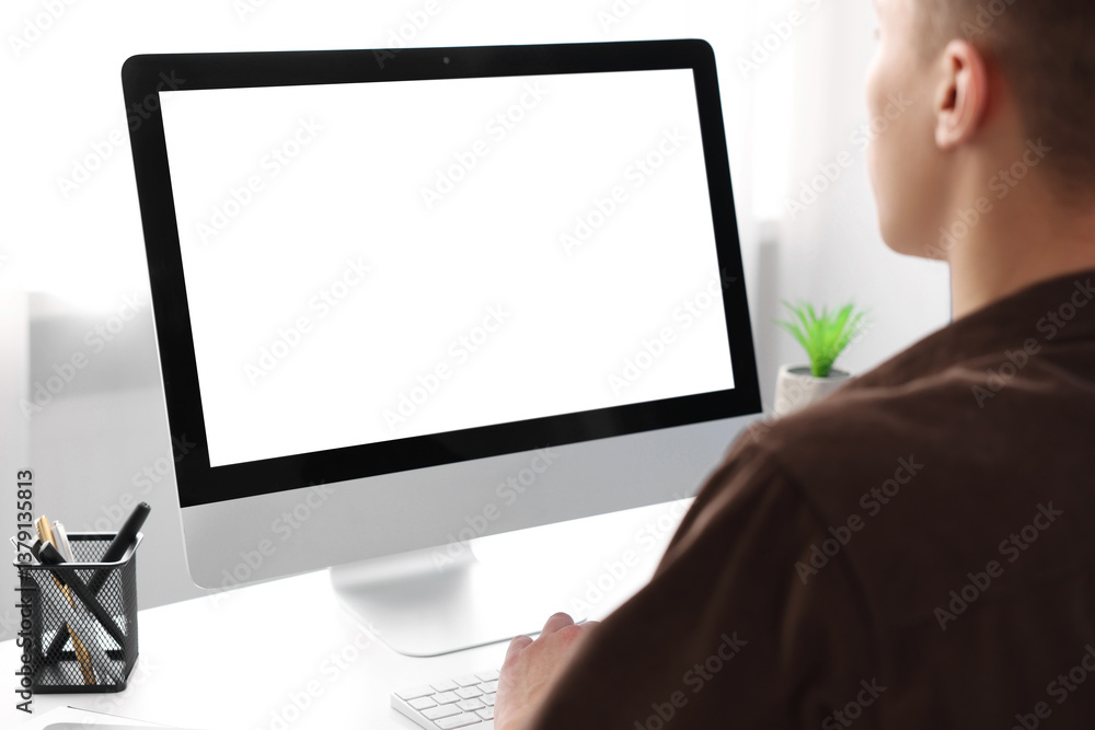 Poster man working on computer at white desk in office, closeup. mockup for design