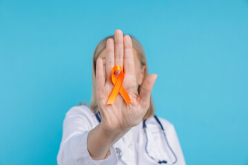 Multiple Sclerosis awareness. Doctor with orange ribbon on light blue background