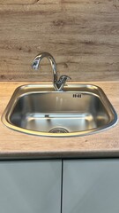 faucet, hand mixer and sink in the kitchen. Plumbing
