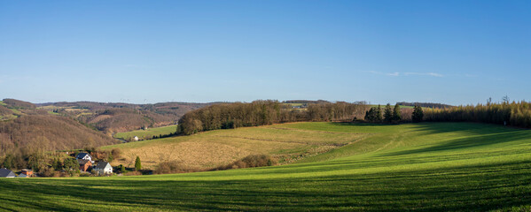Naklejka premium Panoramic photo of countryside in spring with blue sky and clouds on the horizon. German landscape concept