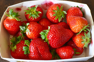 ripe strawberries in a paper box