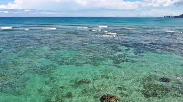Pull away aerial view of clear water at Chun's reef on North Shore, Oahu
