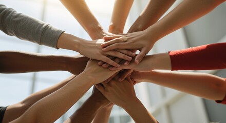 People putting their hands together in a symbol of support