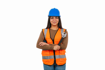 Confident latina construction worker holding adjustable wrench and wearing safety vest