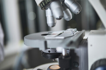 Microscope, sample and study in lab for science research, medical investigation and blood evolution of solution. Biotechnology, closeup and dna particles for bacteria process of pharmaceutical safety