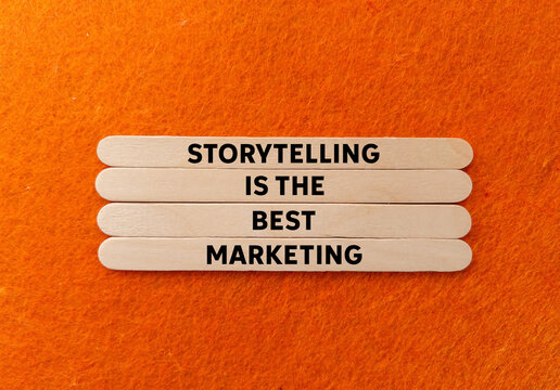 Storytelling is the best marketing message written on wooden sticks on orange background. Conceptual storytelling is the best marketing symbol. Copy space.