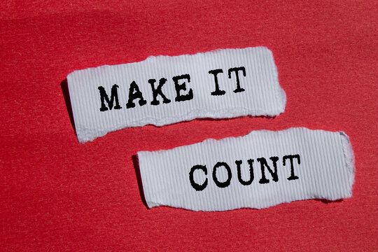 Make it count message written on ripped torn white paper pieces on red background. Conceptual make it count symbol. Copy space.
