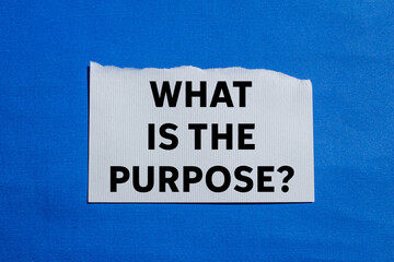 What is the purpose message written on ripped torn white paper piece on blue background. Conceptual...