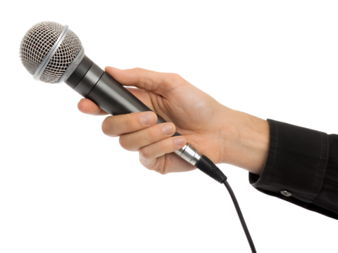 Music performance with a microphone held by a hand in clear focus