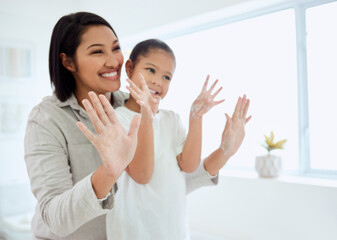 Child, mom and washing hands with happy learning and soap in family home at morning. Cleaning, bathroom and young girl with germ protection and safety with help, love and care from parent for health