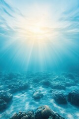 Underwater coral reef with sun rays shining through clear blue water in a tropical ocean