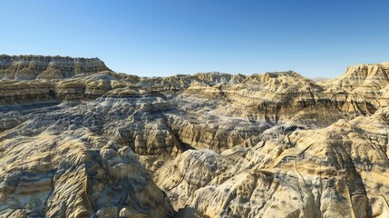 A dramatic canyon landscape with layered rock formations under a clear blue sky