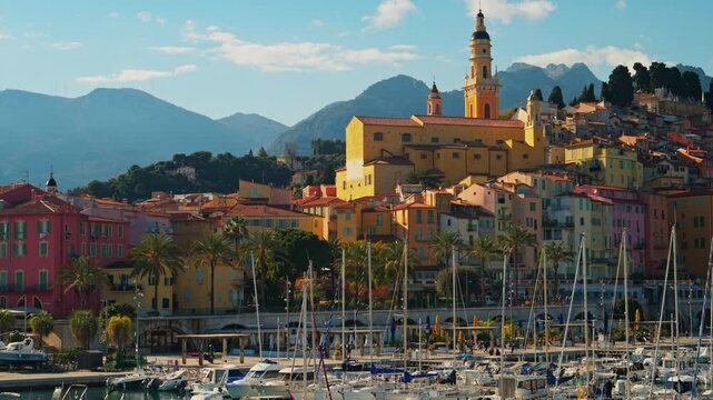 Distant view of the St Michel Basilica surrounded by colourful buildings, Menton, France