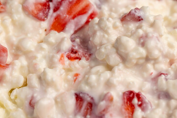 white sour-milk cottage cheese with ripe sweet strawberries cut into pieces