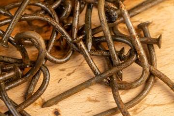 old broken and bent steel nails covered with rust