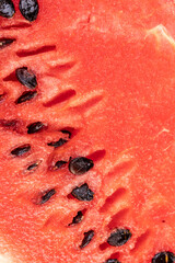 part of a sliced juicy watermelon with black seeds