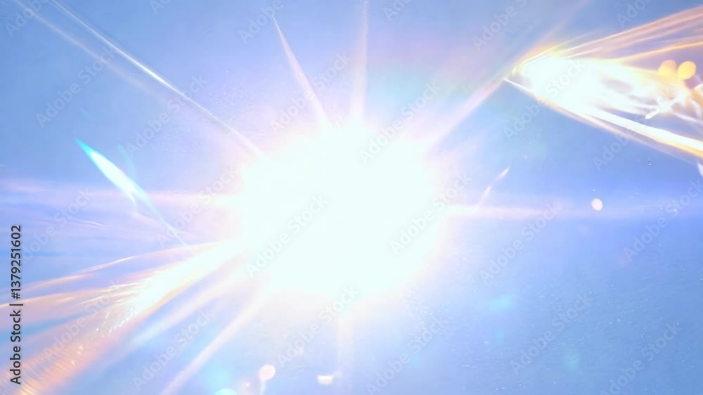 Poster abstract video still of a bright light burst with dynamic flares, captured from a low angle, creatin