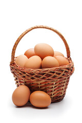 Fresh farm eggs in wicker basket isolated on white background. Concept of healthy organic food