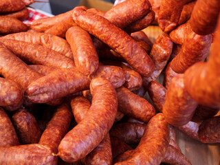 Artisan Smoked Sausages Piled High at Market Stand