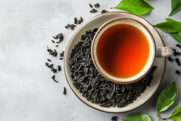 Cup of Black Ceylon Tea with Dried Leaves and Fresh Green Tea Leaf on Ceramic Plate – Natural Wellness Drink Concept