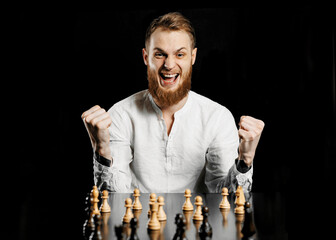 Young man playing chess with intense focus and serious facial expression. Concept of strategic...