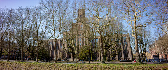 Dutch railway prorail headquarters office in public transportation infrastructure hub seen through winter barren trees along Rijnkade canal