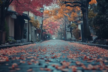 Autumn street scene with orange leaves on ground and trees under soft light