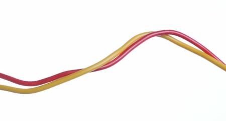 Red and yellow electrical wires on white background