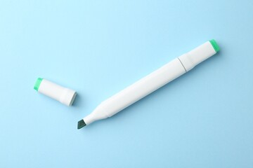One color double sided marker on light blue background, top view