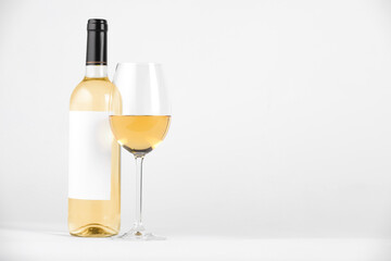 Tasty wine in glass and bottle on white background, space for text