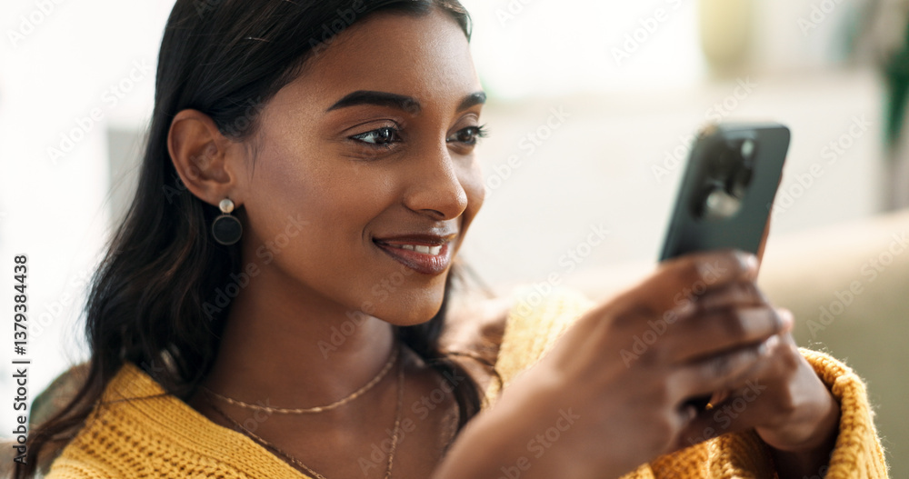 Aufkleber Indian woman, connection and smartphone in home for scroll, typing and text message on sofa in lounge. Girl, network and mobile app for creating profile, chat and choice for match on dating website