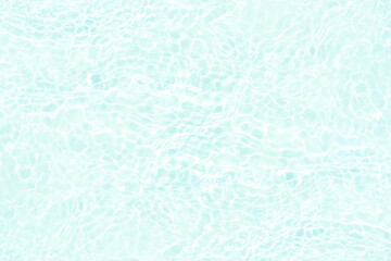 Blue water with ripples on the surface. Defocus blurred transparent blue colored clear calm water surface texture with splashes and bubbles. Water waves with shining pattern texture background.