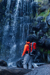 Hiker contemplating majestic apatlaco waterfalls near iztaccihuatl and popocatepetl volcanoes