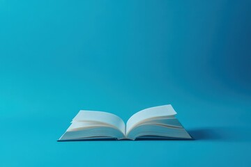 An open book on a solid blue colored background