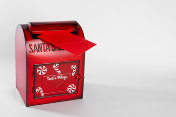 Santa Claus mail box with letter on white background. Christmas tradition