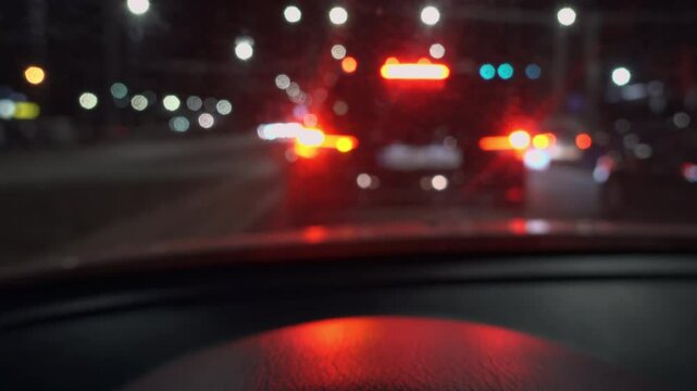 View from a moving car of a car's blinker indicating the direction change at night