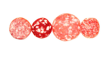 Slices of different tasty smoked sausages on white background, top view