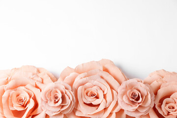 Beautiful pink paper flowers on white background, flat lay. Space for text