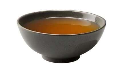 Gray bowl filled with amber liquid on white.......
