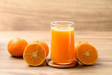Glass of orange juice and fresh orange fruit on wooden background, Healthy drink