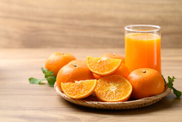 Glass of orange juice and fresh orange fruit on wooden background, Healthy drink