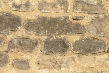 A stone wall background works perfectly for design, architecture, or providing a historical context