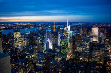 Midtown manhattan skyscrapers at twilight with the hudson river and new jersey in the background